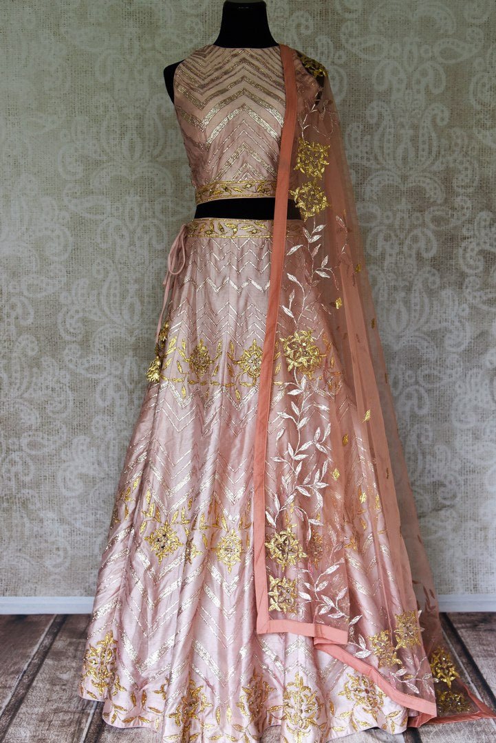 Shop peach color silk applique lehenga with choli & dupatta online in USA. Make your ethnic style absolutely special with a range of designer lehengas, Anarkali suits, Indian clothing available at Pure Elegance Indian fashion store in USA. Find the best Indian dresses for brides in USA also available on our online store.-full view