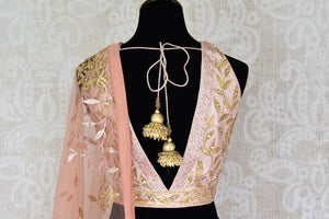 Shop peach color silk applique lehenga with choli & dupatta online in USA. Make your ethnic style absolutely special with a range of designer lehengas, Anarkali suits, Indian clothing available at Pure Elegance Indian fashion store in USA. Find the best Indian dresses for brides in USA also available on our online store.-back