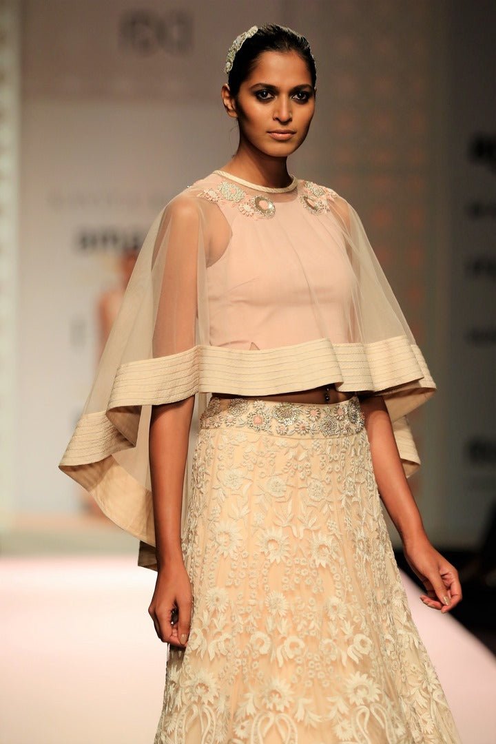 Buy beige color embroidered cape with high low skirt online in USA. Make a captivating fashion statement with a range of Indian designer dresses from Pure Elegance clothing store in USA. If you are looking for online shopping, then look to our online store for a stunning collection of designer lehengas, Indian clothing and much more.-cape