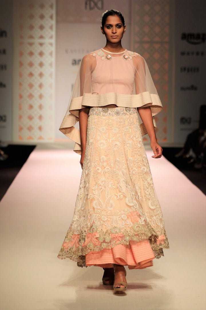 Buy beige color embroidered cape with high low skirt online in USA. Make a captivating fashion statement with a range of Indian designer dresses from Pure Elegance clothing store in USA. If you are looking for online shopping, then look to our online store for a stunning collection of designer lehengas, Indian clothing and much more.-front