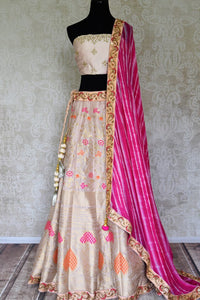 Shop off-white embroidered Banarasi lehenga online in USA with pink dupatta. Get ready to dazzle on weddings and special occasions with an exquisite variety of Indian designer clothes from Pure Elegance Indian clothing store in USA. We have a splendid collection of bridal lehengas, designer sarees, Anarkali suits to make your look absolutely one of kind.-full view