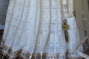 Shop off-white Lucknowi lehenga with silk blouse online in USA and net dupatta. Get ready to dazzle on weddings and special occasions with an exquisite variety of Indian designer clothes from Pure Elegance Indian clothing store in USA. We have a splendid collection of bridal lehengas, designer sarees, Anarkali suits to make your look absolutely one of kind.-bottom