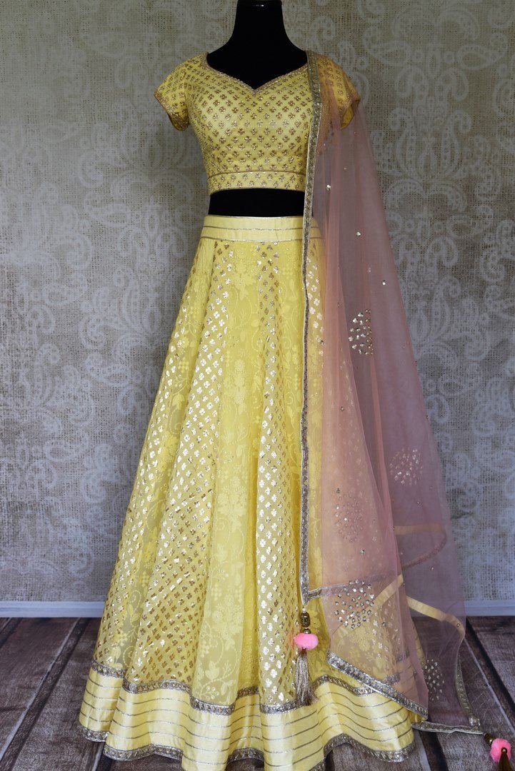 Shop lemon yellow embroidered silk lehenga online in USA and net dupatta. Get ready to dazzle on weddings and special occasions with an exquisite variety of Indian designer clothes from Pure Elegance Indian clothing store in USA. We have a splendid collection of bridal lehengas, designer sarees, Anarkali suits to make your look absolutely one of kind.-full view
