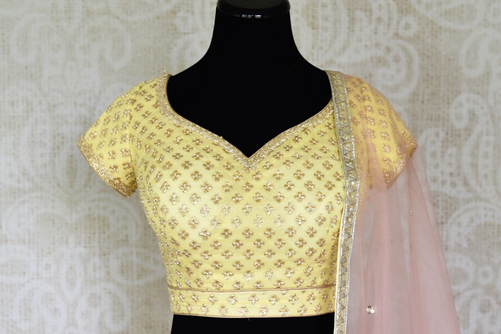 Shop lemon yellow embroidered silk lehenga online in USA and net dupatta. Get ready to dazzle on weddings and special occasions with an exquisite variety of Indian designer clothes from Pure Elegance Indian clothing store in USA. We have a splendid collection of bridal lehengas, designer sarees, Anarkali suits to make your look absolutely one of kind.-front