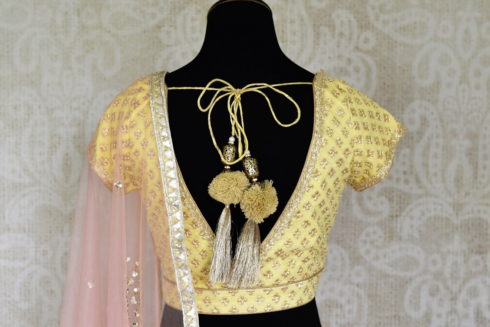 Shop lemon yellow embroidered silk lehenga online in USA and net dupatta. Get ready to dazzle on weddings and special occasions with an exquisite variety of Indian designer clothes from Pure Elegance Indian clothing store in USA. We have a splendid collection of bridal lehengas, designer sarees, Anarkali suits to make your look absolutely one of kind.-back