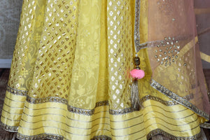 Shop lemon yellow embroidered silk lehenga online in USA and net dupatta. Get ready to dazzle on weddings and special occasions with an exquisite variety of Indian designer clothes from Pure Elegance Indian clothing store in USA. We have a splendid collection of bridal lehengas, designer sarees, Anarkali suits to make your look absolutely one of kind.-bottom