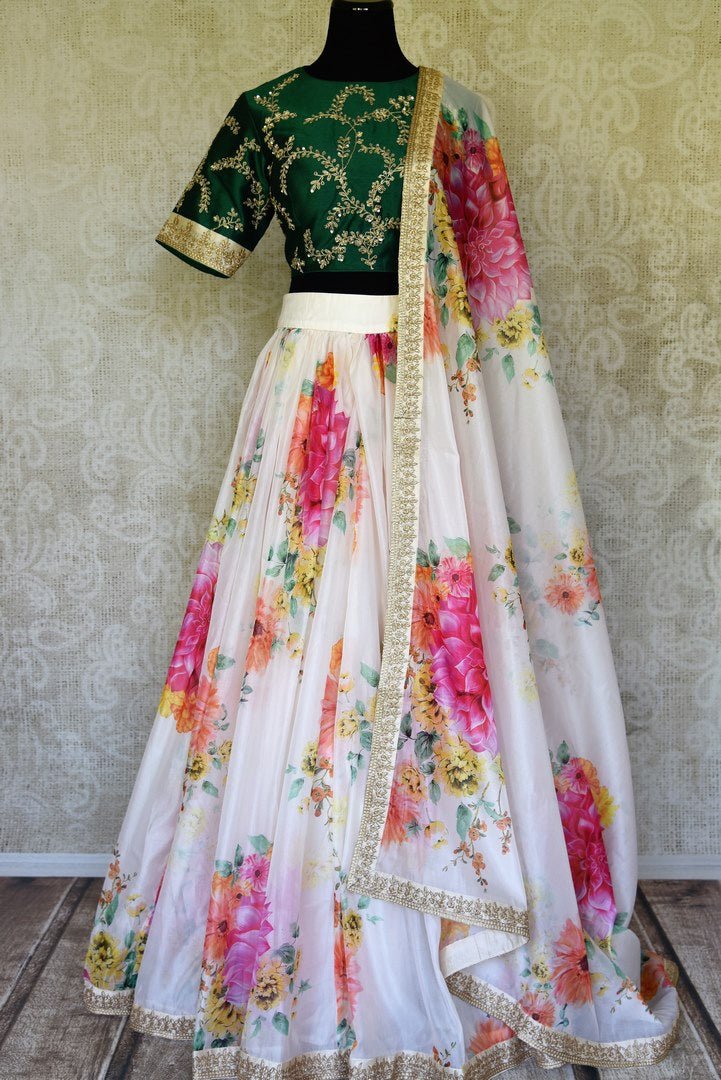 Buy white floral print silk lehenga online in USA with green embroidered blouse. Get ready to dazzle on weddings and special occasions with an exquisite variety of Indian designer clothes from Pure Elegance Indian clothing store in USA. We have a splendid collection of bridal lehengas, designer sarees, Anarkali suits to make your look absolutely one of kind.-full view