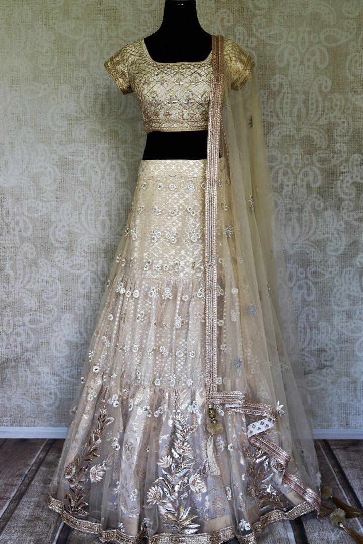 Shop gold embroidered net silk lehenga online in USA with dupatta. Get ready to dazzle on weddings and special occasions with an exquisite variety of Indian designer clothes from Pure Elegance Indian clothing store in USA. We have a splendid collection of bridal lehengas, designer sarees, Anarkali suits to make your look absolutely one of kind.-full view