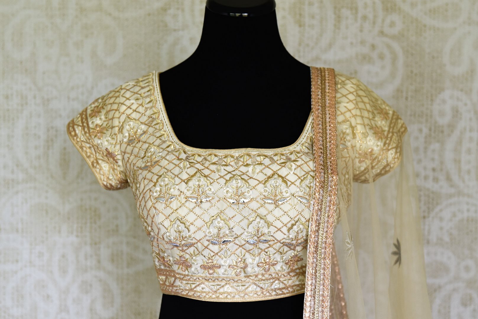 Shop gold embroidered net silk lehenga online in USA with dupatta. Get ready to dazzle on weddings and special occasions with an exquisite variety of Indian designer clothes from Pure Elegance Indian clothing store in USA. We have a splendid collection of bridal lehengas, designer sarees, Anarkali suits to make your look absolutely one of kind.-front