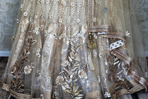 Shop gold embroidered net silk lehenga online in USA with dupatta. Get ready to dazzle on weddings and special occasions with an exquisite variety of Indian designer clothes from Pure Elegance Indian clothing store in USA. We have a splendid collection of bridal lehengas, designer sarees, Anarkali suits to make your look absolutely one of kind.-bottom