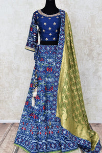 Buy dark blue patola print gota work silk lehenga online in USA with green dupatta. Be the talk of weddings and special occasions with a splendid collection of Indian designer lehengas from Pure Elegance Indian clothing store in USA. We have a spectacular range of bridal lehengas for Indian brides in USA. -full view