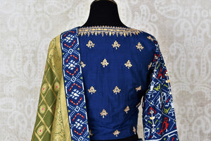 Buy dark blue patola print gota work silk lehenga online in USA with green dupatta. Be the talk of weddings and special occasions with a splendid collection of Indian designer lehengas from Pure Elegance Indian clothing store in USA. We have a spectacular range of bridal lehengas for Indian brides in USA. -back