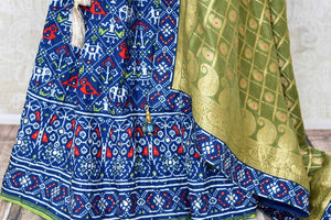 Buy dark blue patola print gota work silk lehenga online in USA with green dupatta. Be the talk of weddings and special occasions with a splendid collection of Indian designer lehengas from Pure Elegance Indian clothing store in USA. We have a spectacular range of bridal lehengas for Indian brides in USA. -bottom