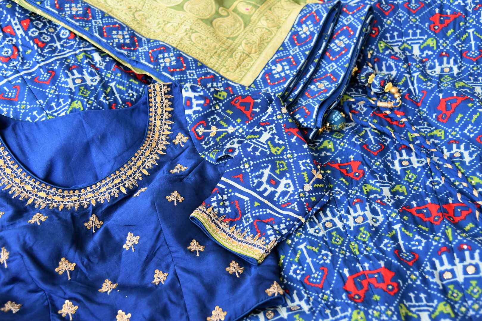 Buy dark blue patola print gota work silk lehenga online in USA with green dupatta. Be the talk of weddings and special occasions with a splendid collection of Indian designer lehengas from Pure Elegance Indian clothing store in USA. We have a spectacular range of bridal lehengas for Indian brides in USA. -details