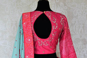 Shop sky blue and pink embroidered silk bandhej lehenga online in USA with dupatta. Be the talk of weddings and special occasions with a splendid collection of Indian designer lehengas from Pure Elegance Indian clothing store in USA. We have a spectacular range of bridal lehengas for Indian brides in USA. -back