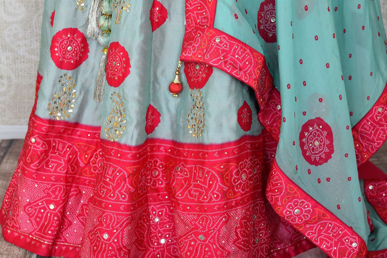 Shop sky blue and pink embroidered silk bandhej lehenga online in USA with dupatta. Be the talk of weddings and special occasions with a splendid collection of Indian designer lehengas from Pure Elegance Indian clothing store in USA. We have a spectacular range of bridal lehengas for Indian brides in USA. -bottom