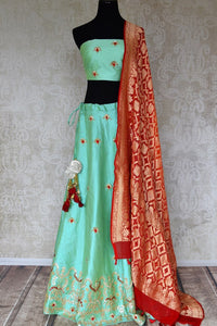 Buy green raw silk lehenga online in USA with gota patti work and red dupatta. Make fashionable choices with latest Indian designer clothing from Pure Elegance Indian fashion store in USA. Shop Indian salwar suits, designer Anarkali suits and bridal lehengas for Indian brides in USA from our online store.-full view
