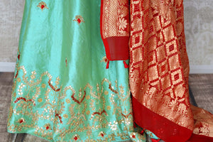 Buy green raw silk lehenga online in USA with gota patti work and red dupatta. Make fashionable choices with latest Indian designer clothing from Pure Elegance Indian fashion store in USA. Shop Indian salwar suits, designer Anarkali suits and bridal lehengas for Indian brides in USA from our online store.-skirt