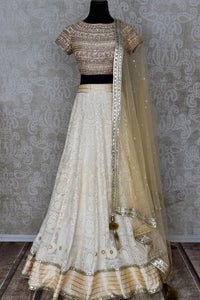 Shop off-white embroidered Lucknowi lehenga online in USA with dupatta. Pick your favorite Indian clothing from a colorful collection available at Pure Elegance Indian fashion store in USA. We have an alluring range of wedding lehengas, designer Anarkali suits, gowns for Indian women in USA.-full view