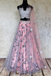Shop pink and grey floral embroidered silk lehenga online in USA with net overlay and dupatta. Keep your wardrobe update with latest Indian designer clothese from Pure Elegance Indian fashion store in USA. Shop traditional Anarkali suits, designer lehengas for Indian brides in USA from our online store.-full view