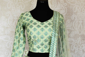 Buy pastel green printed silk lehenga online in USA with hand embroidery. Make fashionable choices with latest Indian designer clothing from Pure Elegance Indian fashion store in USA. Shop Indian salwar suits, designer Anarkali suits and bridal lehengas for Indian brides in USA from our online store.-front