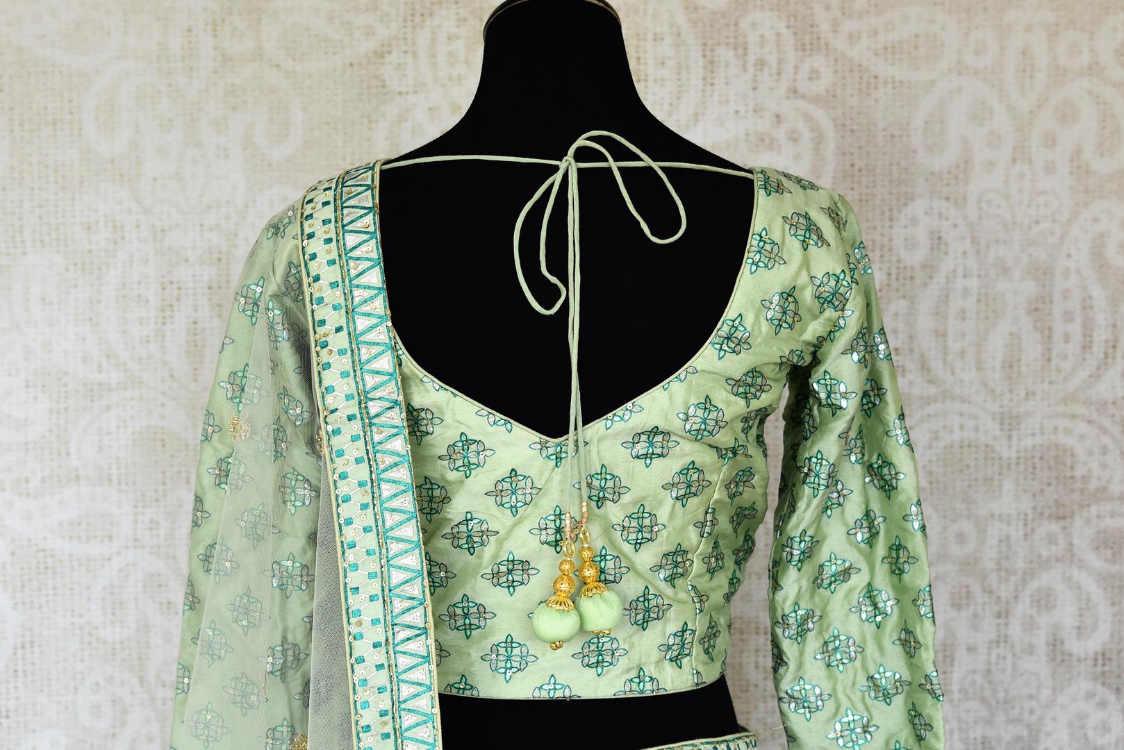 Buy pastel green printed silk lehenga online in USA with hand embroidery. Make fashionable choices with latest Indian designer clothing from Pure Elegance Indian fashion store in USA. Shop Indian salwar suits, designer Anarkali suits and bridal lehengas for Indian brides in USA from our online store.-back