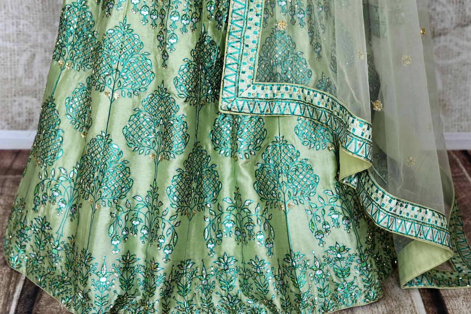 Buy pastel green printed silk lehenga online in USA with hand embroidery. Make fashionable choices with latest Indian designer clothing from Pure Elegance Indian fashion store in USA. Shop Indian salwar suits, designer Anarkali suits and bridal lehengas for Indian brides in USA from our online store.-bottom