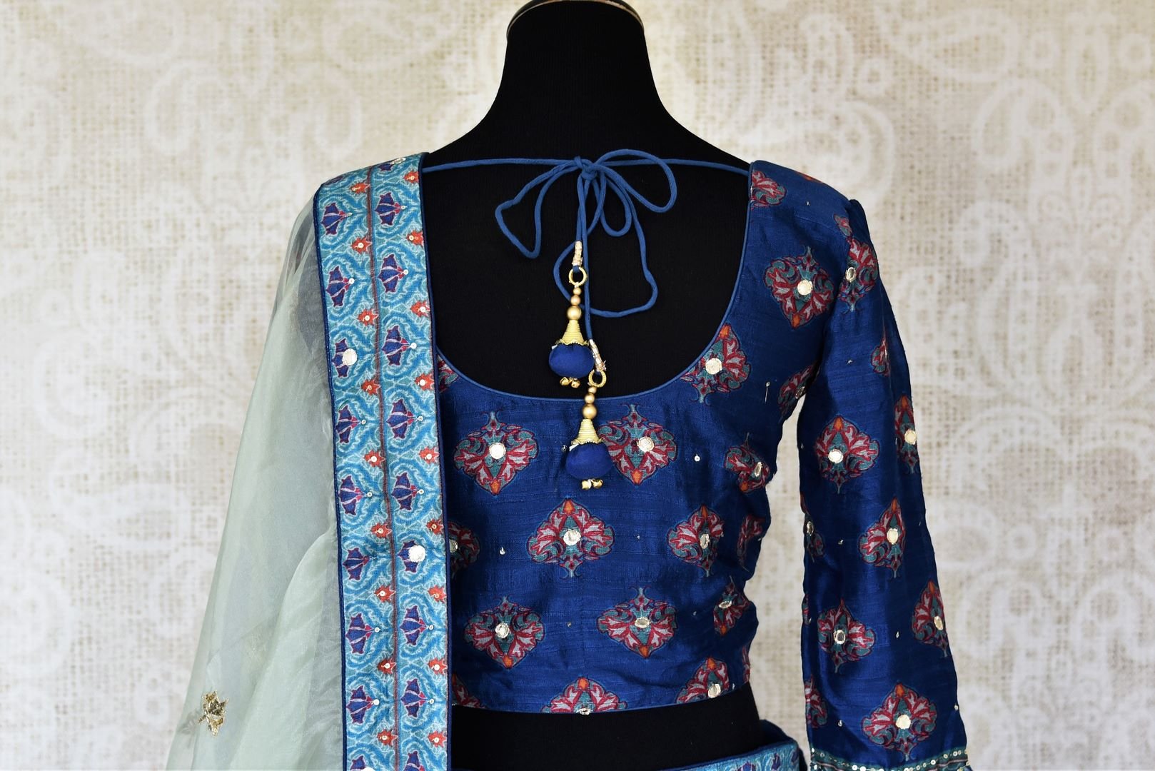 Shop blue printed silk lehenga online in USA with hand embroidery. Make fashionable choices with latest Indian designer clothing from Pure Elegance Indian fashion store in USA. Shop Indian salwar suits, designer Anarkali suits and bridal lehengas for Indian brides in USA from our online store.-back