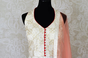 Buy cream embroidered net Anarkali suit online in USA with pants. Step up your ethnic fashion game with exquisite variety of designer Anarkali suits from Pure Elegance Indian clothing store in USA. Shop online.-front