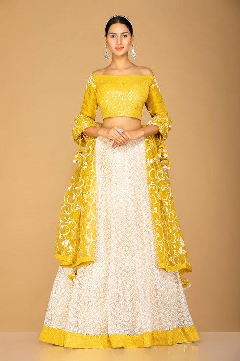 Shop beautiful yellow and white designer lehenga online in USA with dupatta. Gear up for the festive season with exquisite designer lehengas, Anarkali suits. Indian dresses from Pure Elegance Indian fashion store in USA. Shop online now.-full view