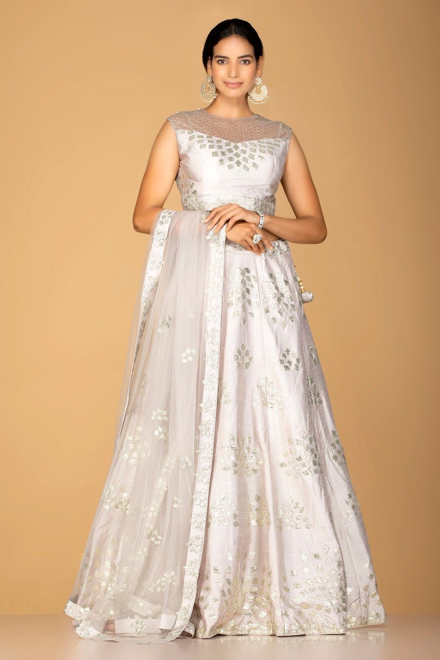 Shop grey silver applique work chanderi silk lehenga online in USA with dupatta. Gear up for the festive season with exquisite designer lehengas, Anarkali suits. Indian dresses from Pure Elegance Indian fashion store in USA. Shop online now.-full view
