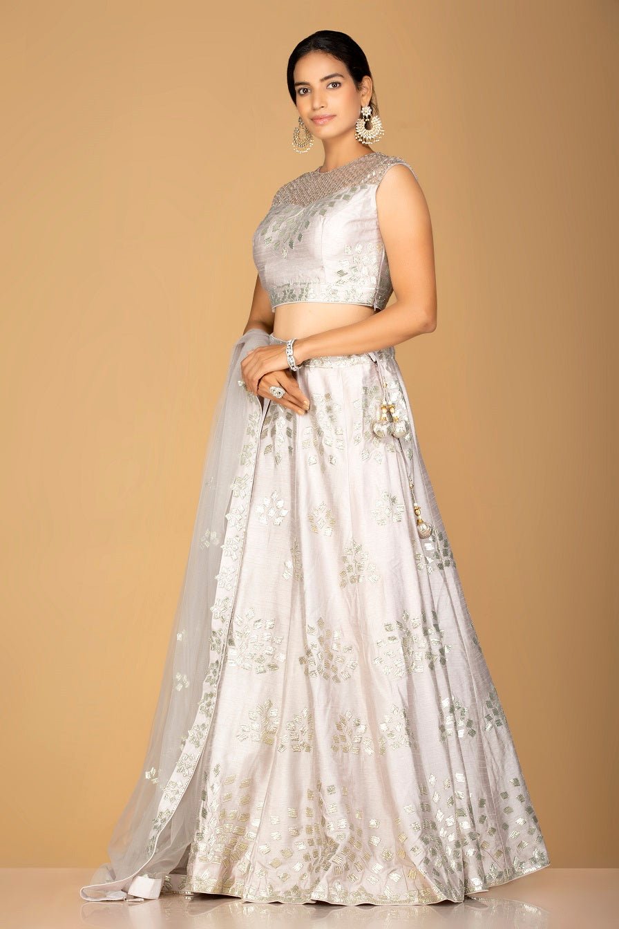 Shop grey silver applique work chanderi silk lehenga online in USA with dupatta. Gear up for the festive season with exquisite designer lehengas, Anarkali suits. Indian dresses from Pure Elegance Indian fashion store in USA. Shop online now.-side