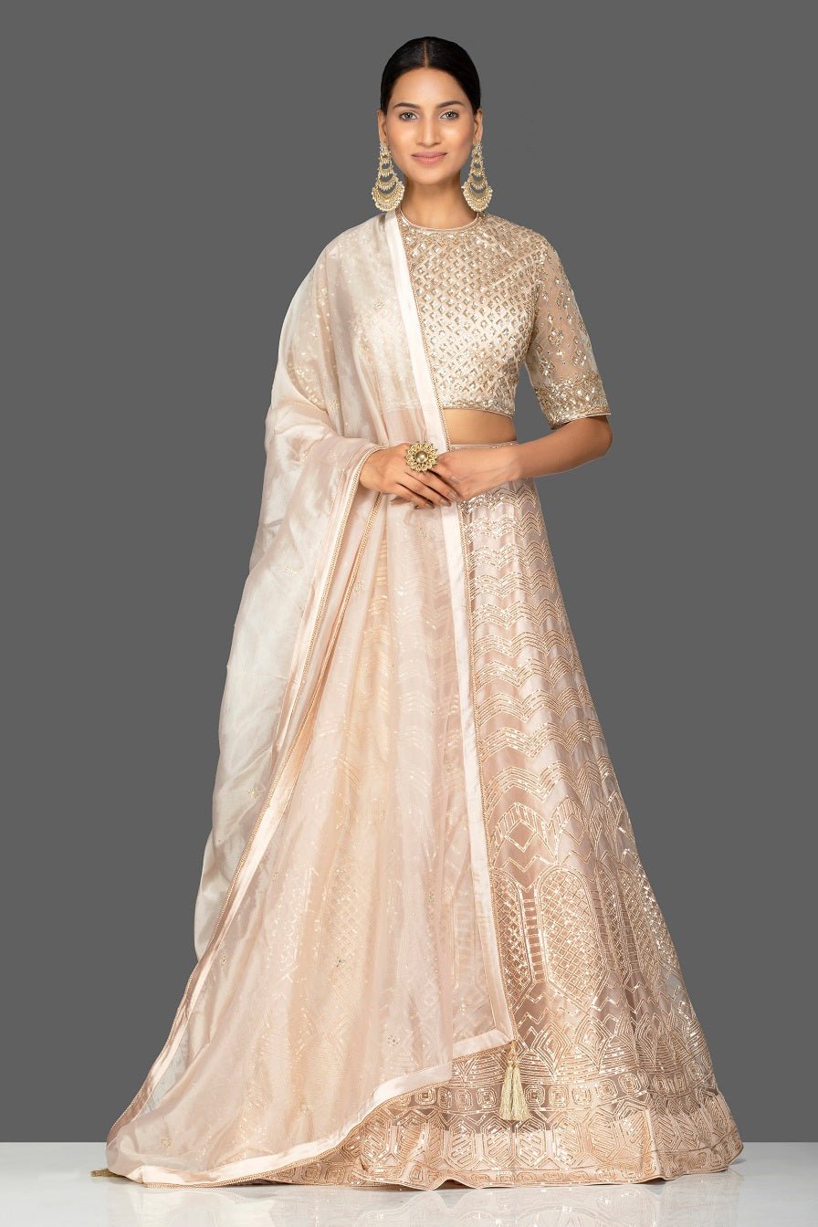 Shop beautiful cream embroidered net lehenga online in USA with dupatta. Gear up for the festive season with exquisite designer lehengas, Anarkali suits. Indian dresses from Pure Elegance Indian fashion store in USA. Shop online now.-full view