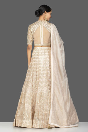 Shop beautiful cream embroidered net lehenga online in USA with dupatta. Gear up for the festive season with exquisite designer lehengas, Anarkali suits. Indian dresses from Pure Elegance Indian fashion store in USA. Shop online now.-back