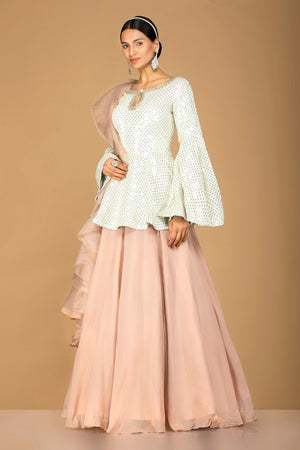 Shop gorgeous off-white and beige embroidered net lehenga online in USA with sequin embroidery. Gear up for the festive season with exquisite designer lehengas, Anarkali suits. Indian dresses from Pure Elegance Indian fashion store in USA. Shop online now.-side