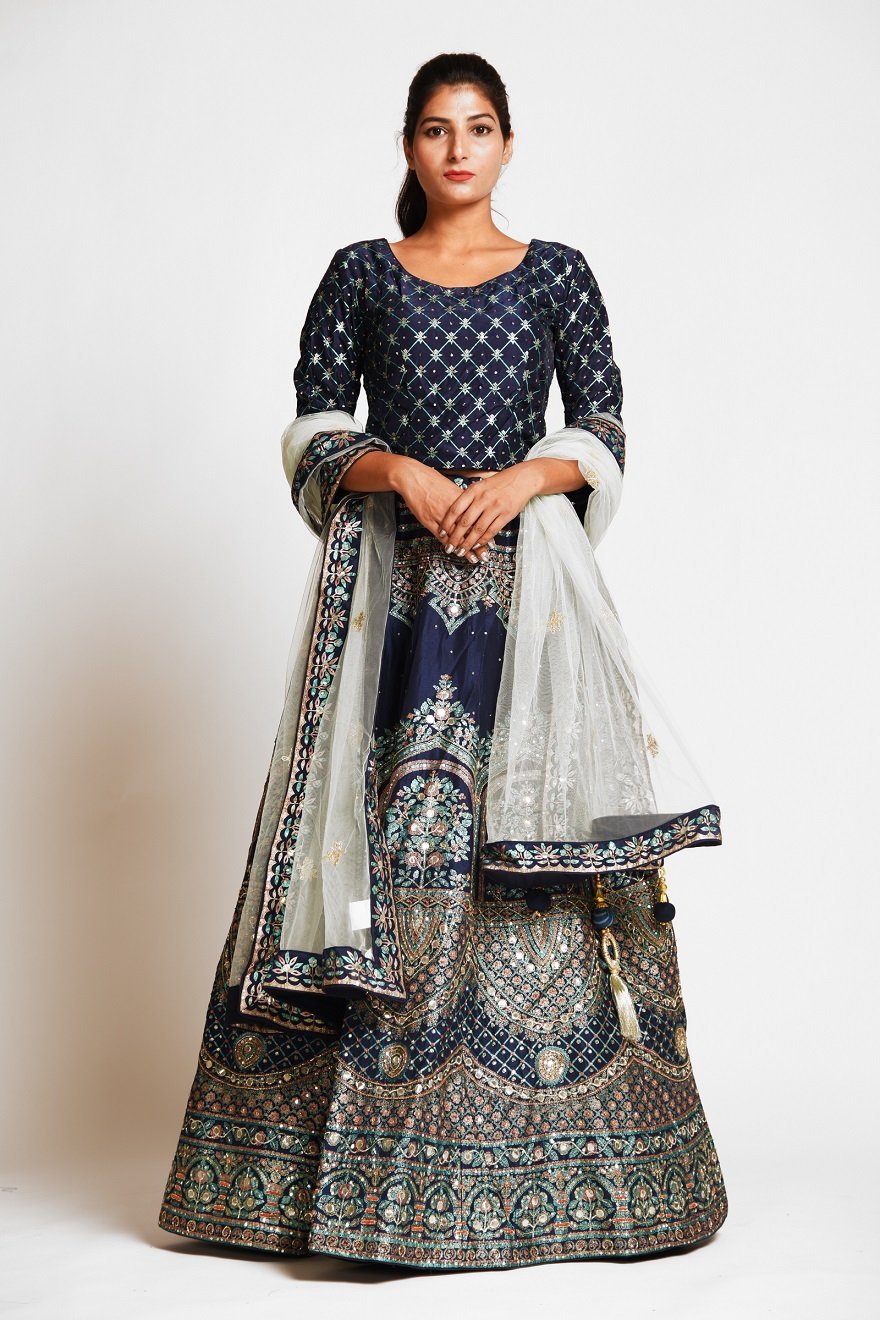 Buy navy blue embroidered designer silk lehenga online in USA with white net dupatta. Elevate your traditional Indian style with exquisite designer lehengas, Anarkali suits, traditional salwar suits from Pure Elegance Indian clothing store in USA.-front