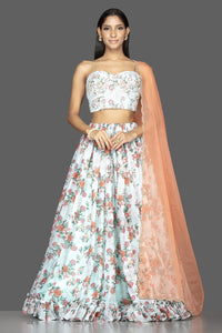 Buy mint green embroidered organza floral lehenga online in USA with peach dupatta. Spread ethnic elegance on weddings and special occasions in splendid designer lehengas, Indowestern dresses crafted with exquisite Indian craftsmanship from Pure Elegance Indian fashion store in USA.-front