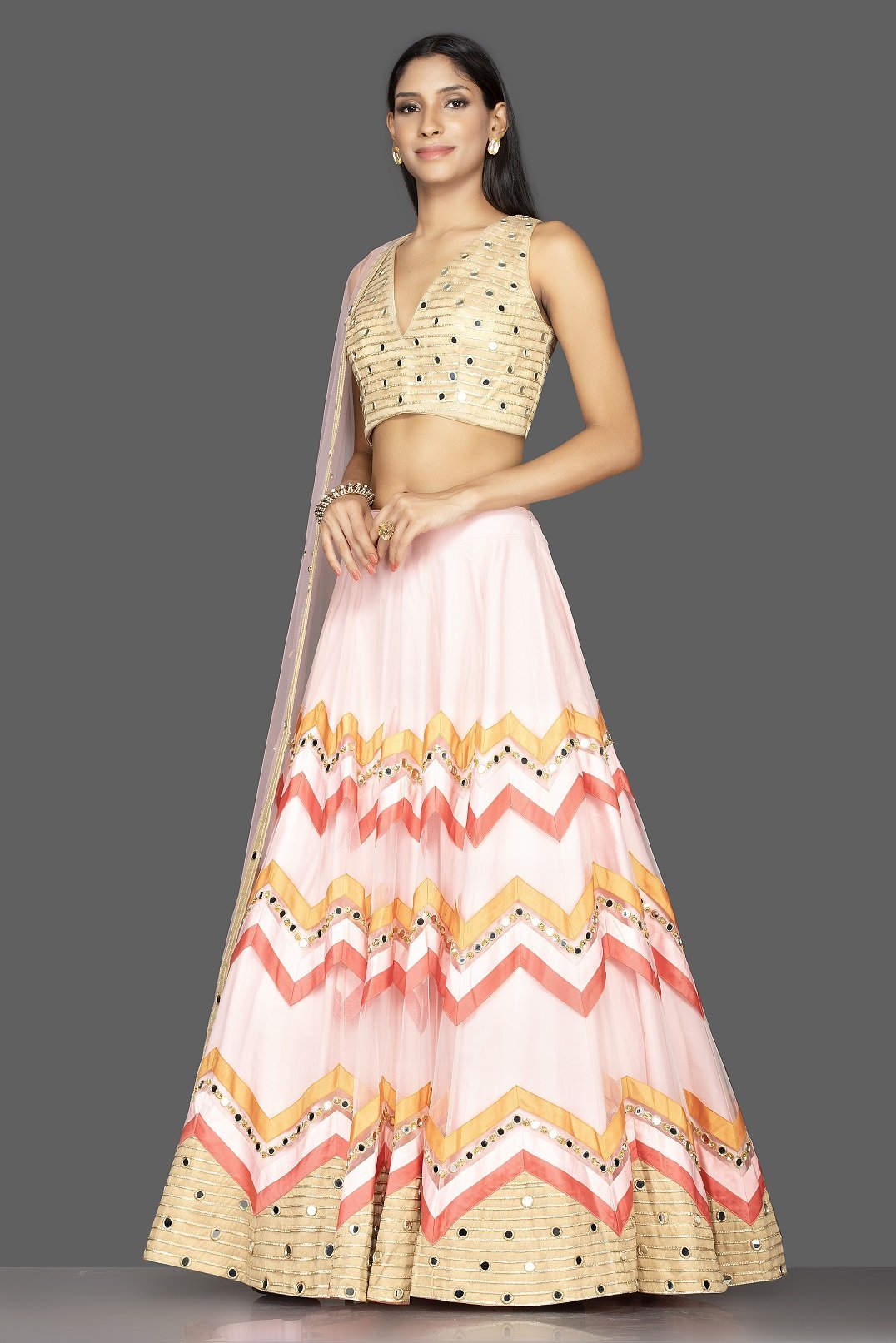 Buy glamorous powder pink chevron design mirror work lehenga online in USA with matching dupatta. Spread ethnic elegance on weddings and special occasions in splendid designer lehengas, Indowestern dresses crafted with exquisite Indian craftsmanship from Pure Elegance Indian fashion store in USA.-side
