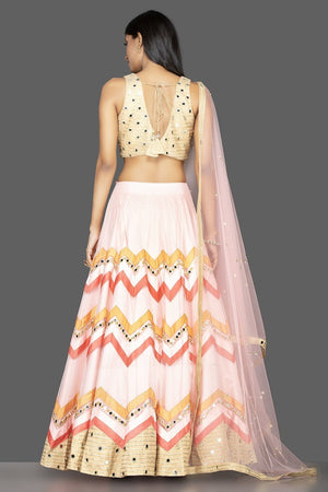 Buy glamorous powder pink chevron design mirror work lehenga online in USA with matching dupatta. Spread ethnic elegance on weddings and special occasions in splendid designer lehengas, Indowestern dresses crafted with exquisite Indian craftsmanship from Pure Elegance Indian fashion store in USA.-back