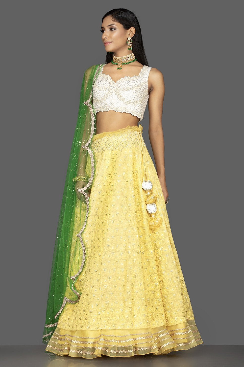 Shop beautiful yellow and off-white Lucknowi work georgette lehenga online in USA with green net dupatta. Look radiant on weddings and special occasions in splendid designer lehengas crafted with finest embroideries and stunning silhouettes from Pure Elegance Indian fashion boutique in USA.-side