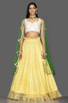 Shop beautiful yellow and off-white Lucknowi work georgette lehenga online in USA with green net dupatta. Look radiant on weddings and special occasions in splendid designer lehengas crafted with finest embroideries and stunning silhouettes from Pure Elegance Indian fashion boutique in USA.-full view