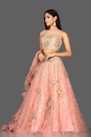 Shop exquisite dusty pink zardozi embroidery net lehenga online in USA with net dupatta. Look radiant on weddings and special occasions in splendid designer lehengas crafted with finest embroideries and stunning silhouettes from Pure Elegance Indian fashion boutique in USA..-side