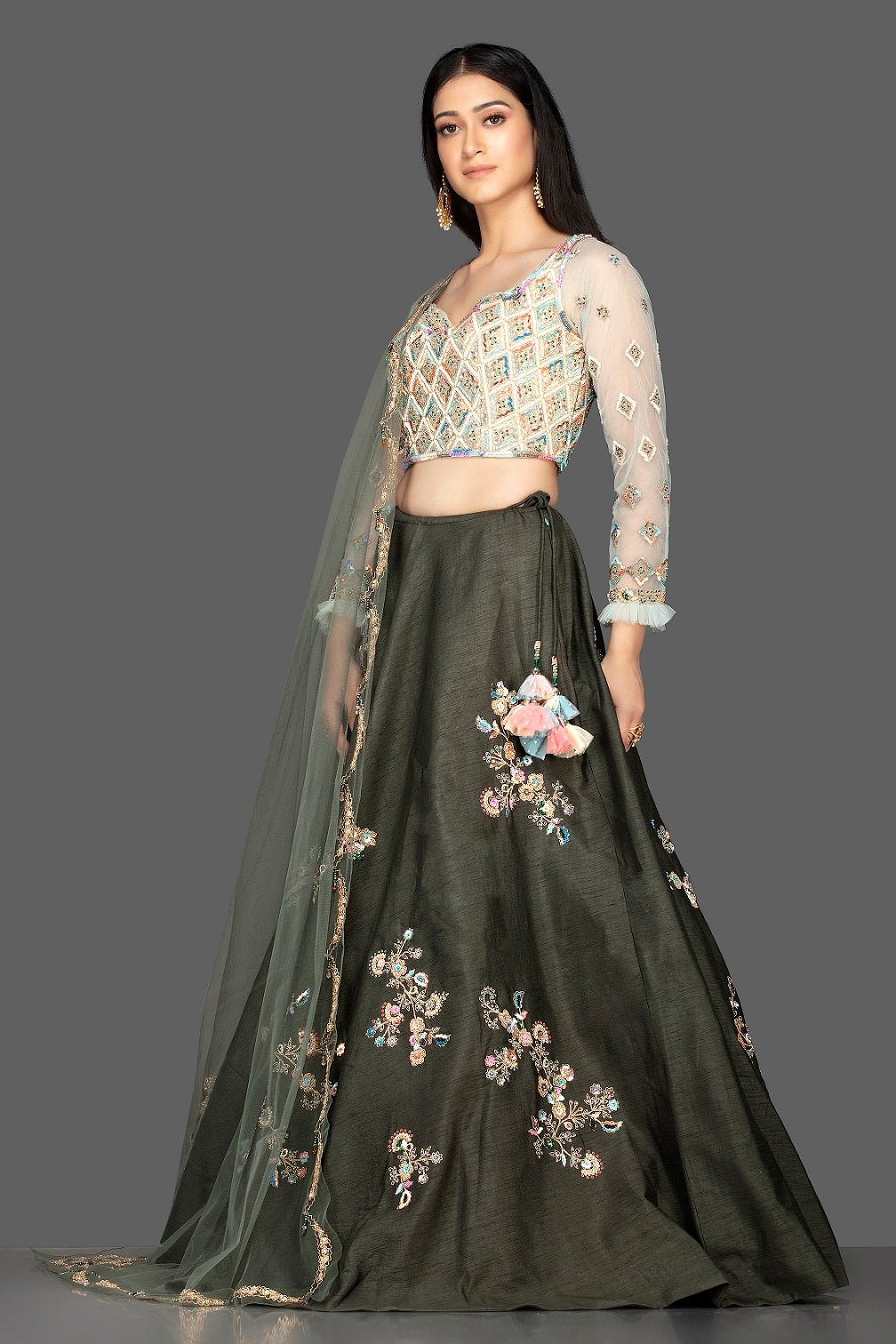 Buy beautiful dark grey embroidered raw silk lehenga online in USA with net dupatta. Look radiant on weddings and special occasions in splendid designer lehengas crafted with finest embroideries and stunning silhouettes from Pure Elegance Indian fashion boutique in USA.-full view