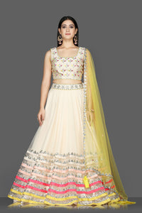 Shop cream embroidered net and raw silk lehenga online in USA with yellow dupatta. Flaunt ethnic fashion with exquisite designer lehenga, Indian wedding dresses from Pure Elegance Indian fashion boutique in USA.-full view