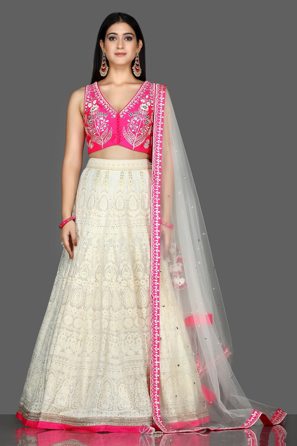 Buy beautiful white and pink Lucknowi embroidery lehenga online in USA with dupatta. Flaunt ethnic fashion with exquisite designer lehenga, Indian wedding dresses from Pure Elegance Indian fashion boutique in USA.-full view