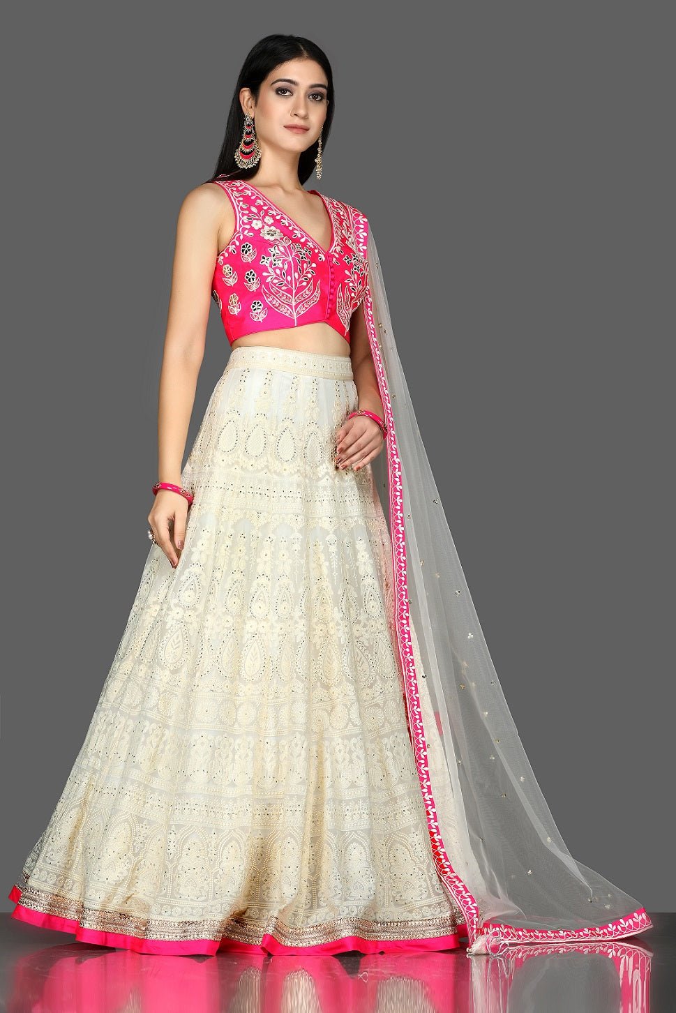 Buy beautiful white and pink Lucknowi embroidery lehenga online in USA with dupatta. Flaunt ethnic fashion with exquisite designer lehenga, Indian wedding dresses from Pure Elegance Indian fashion boutique in USA.-right side