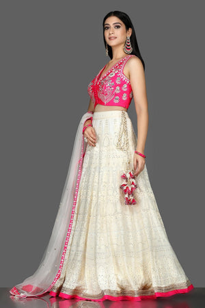 Buy beautiful white and pink Lucknowi embroidery lehenga online in USA with dupatta. Flaunt ethnic fashion with exquisite designer lehenga, Indian wedding dresses from Pure Elegance Indian fashion boutique in USA.-left side