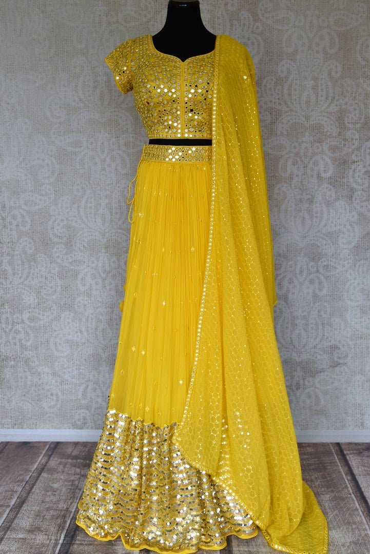 Shop stunning yellow mirror work net and georgette lehenga online in USA. Be occasion ready in stunning designer dresses, lehengas, palazzo suits, sharara suits, bridal lehengas from Pure Elegance Indian clothing store in USA.-full view