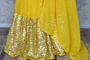 Shop stunning yellow mirror work net and georgette lehenga online in USA. Be occasion ready in stunning designer dresses, lehengas, palazzo suits, sharara suits, bridal lehengas from Pure Elegance Indian clothing store in USA.-skirt