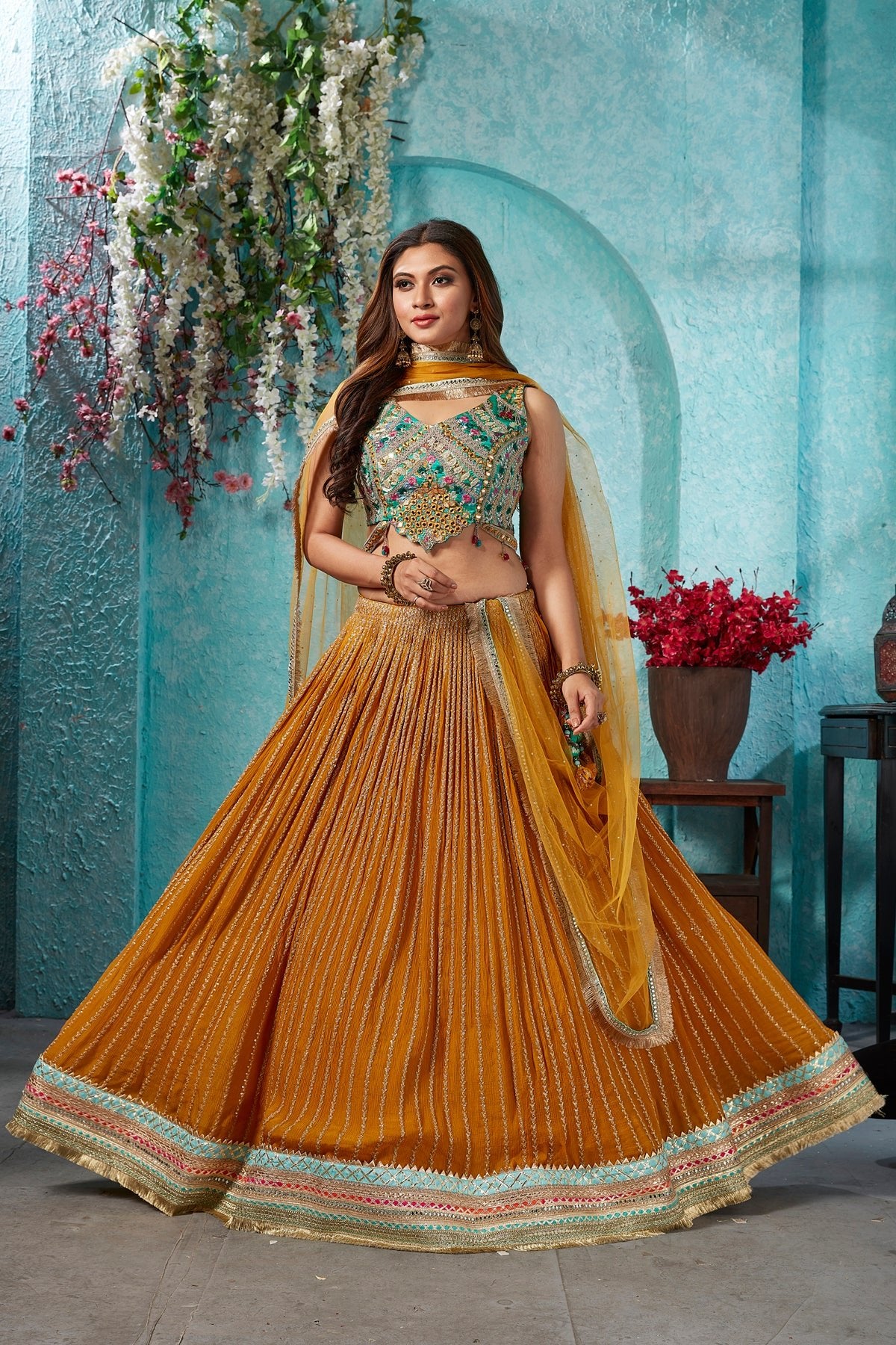 Buy beautiful mustard embroidered georgette lehenga online in USA with embroidered green blouse. Dazzle at weddings and parties in exquisite Indian designerwear dresses, designer lehengas, Anarkali suits, gowns, palazzo suits, sharara suits from Pure Elegance Indian fashion store in USA.-full view